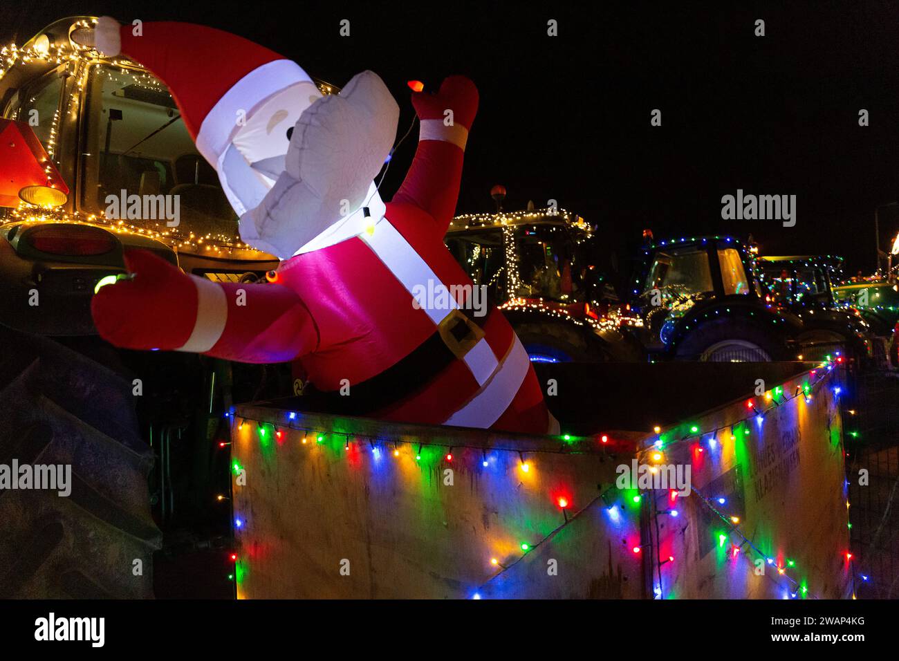 Tractors decorated with lights go for a ride during Christmas Stock