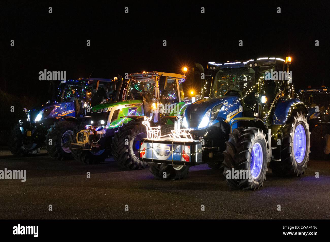 Tractors decorated with lights go for a ride during Christmas Stock