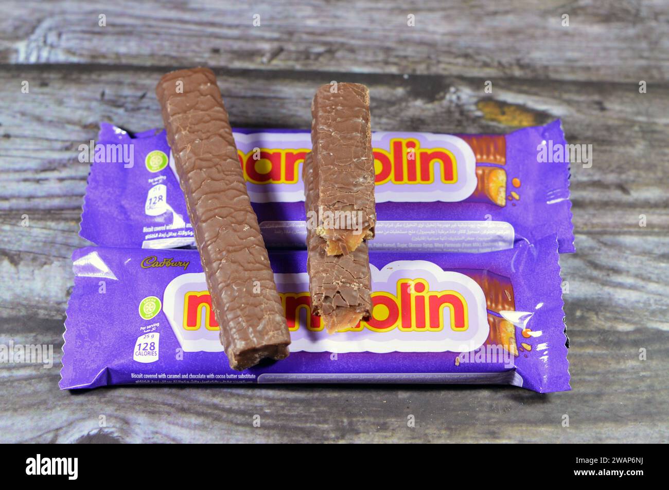 Cairo, Egypt, January 1 2024: Mandolin Biscuit Covered with Caramel and Chocolate, Cadbury Mandolin bars with Ingredients of Stock Photo