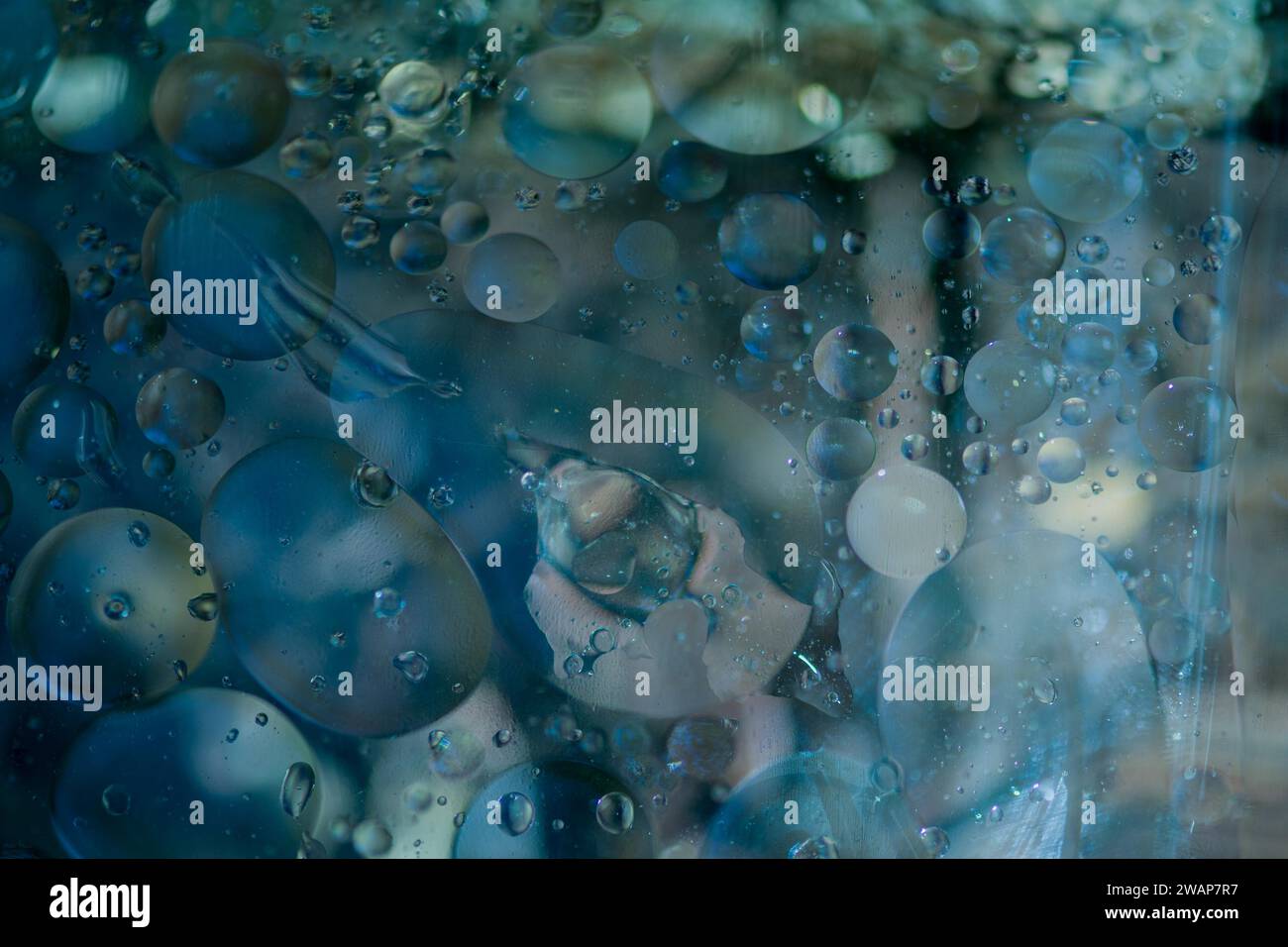 Abstract oil in water using natural light in blue tones. Good for wallpaper or background Stock Photo