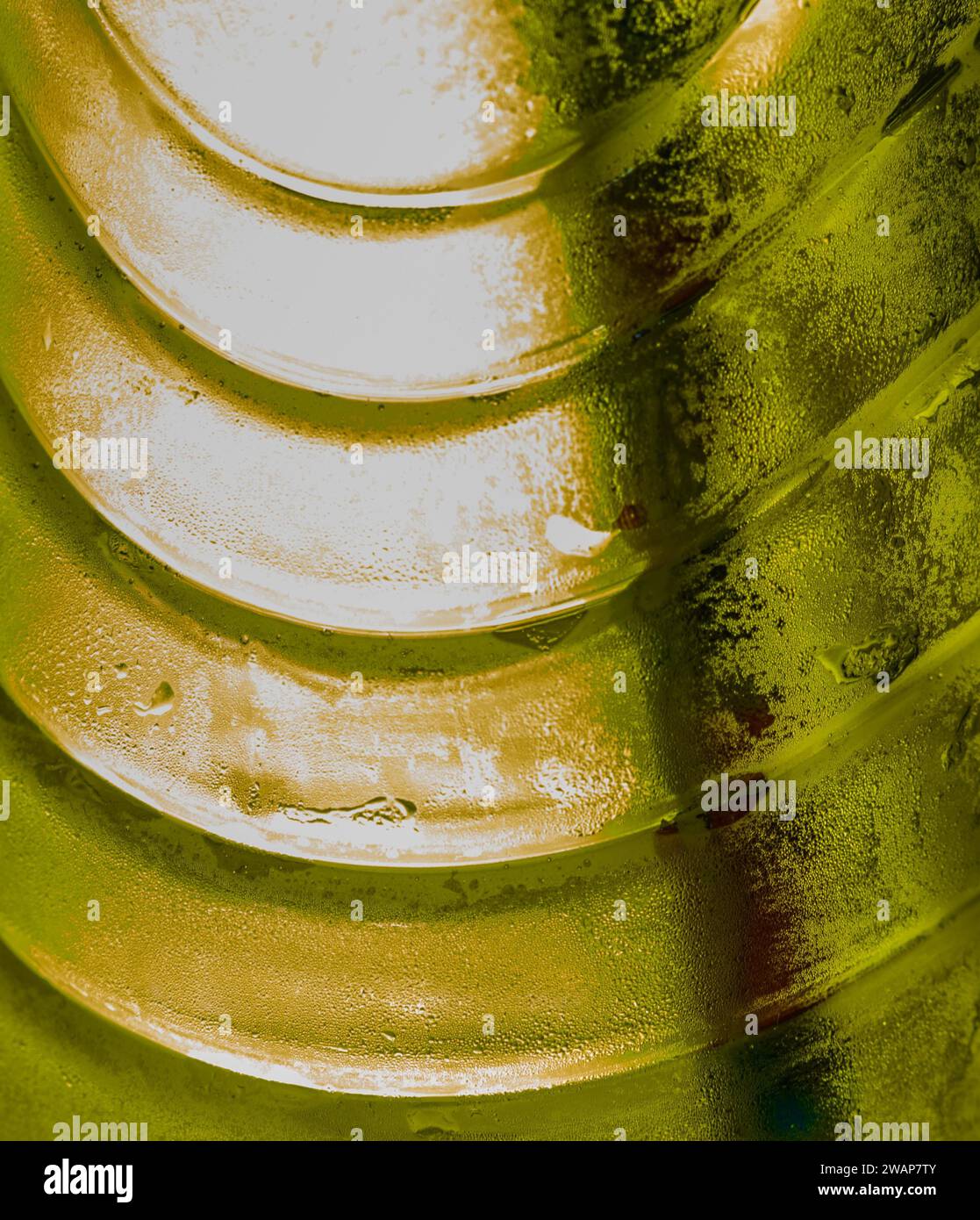 Closeup of bottle of drinking water back lit with yellow LED lights ...
