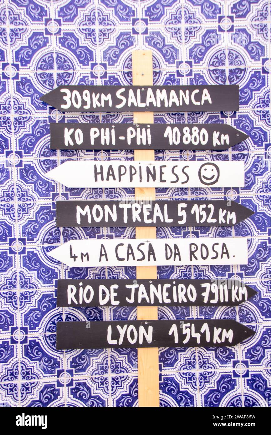 directional signage with funny different directions on a wall in the ...