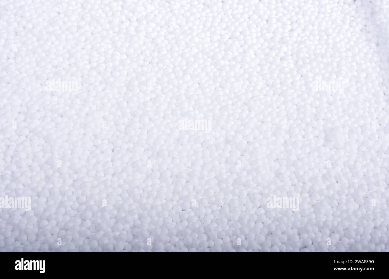 White little polystyrene foam balls as background Stock Photo - Alamy