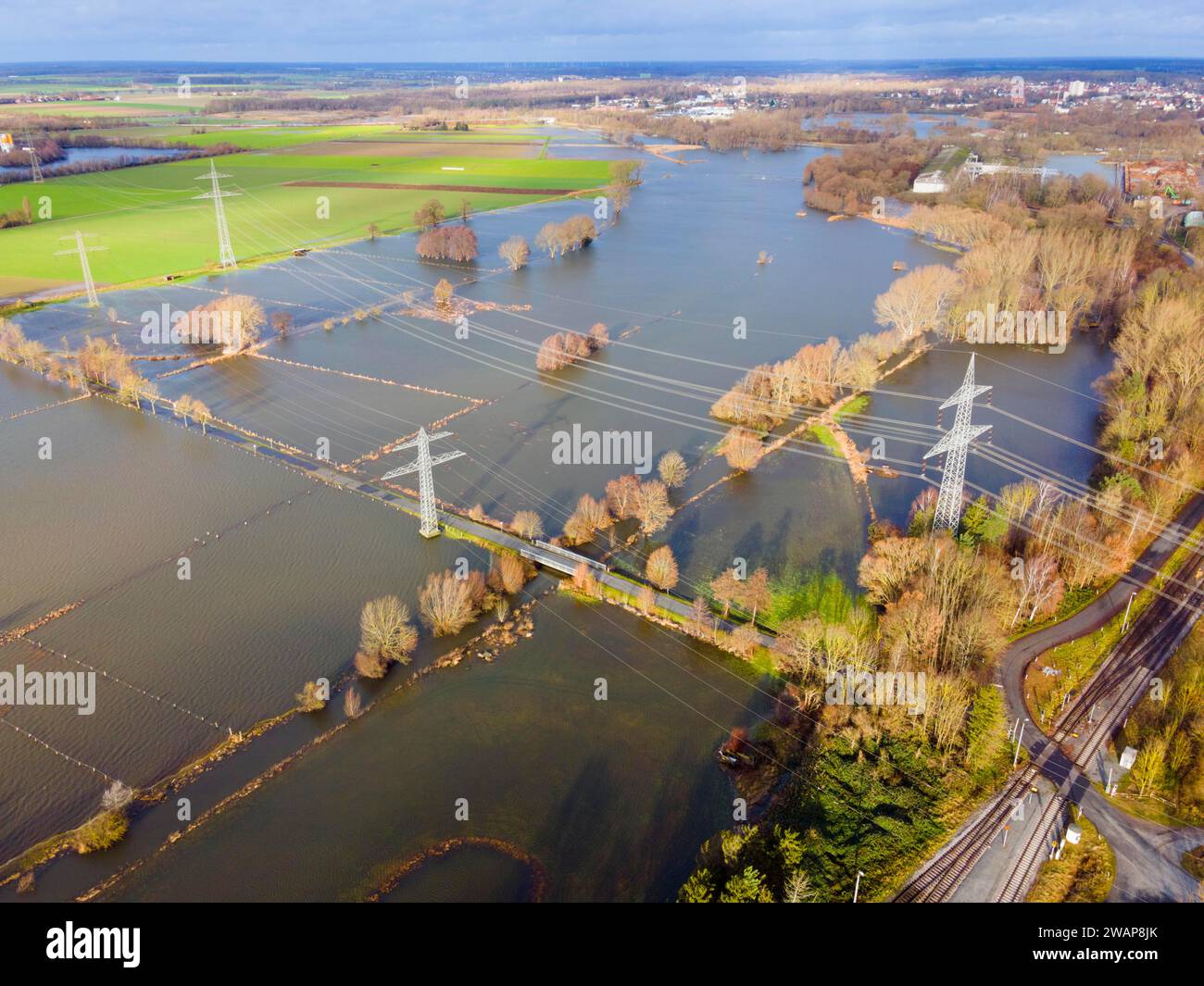 An aerial photograph shows flooded fields and landscape with electricity pylons and cloudy sky, flood, Christmas, 2023, Fuhse, between Klein Ilsede an Stock Photo