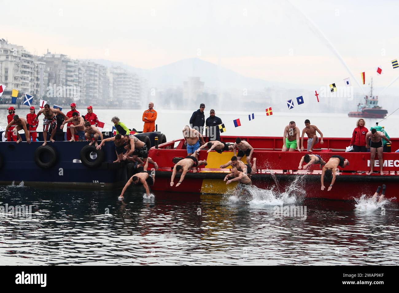 Thessaloniki, Greece. 6th Jan, 2024. Swimmers dive to retrieve a cross