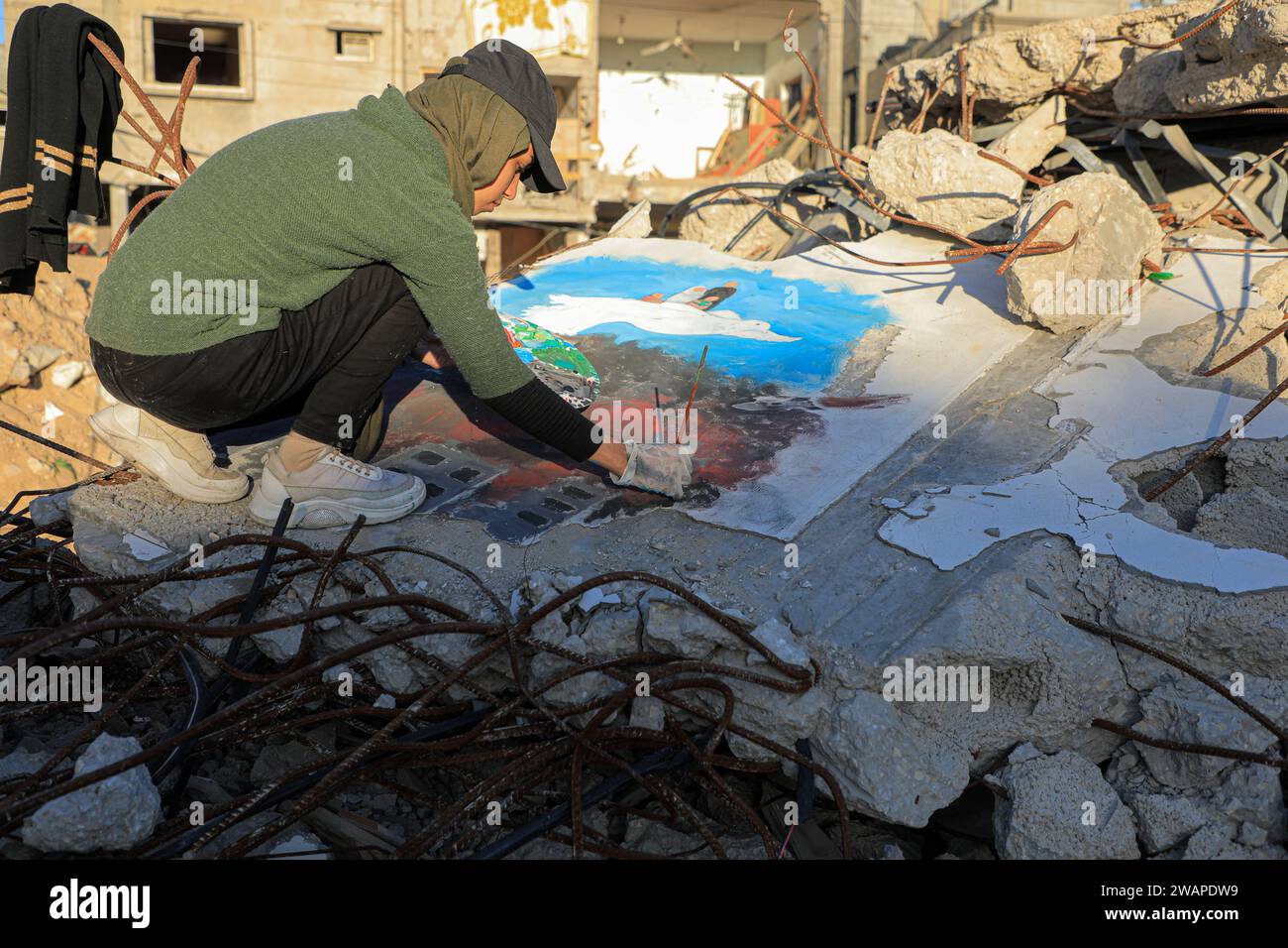 Rafah 5th Jan 2024 Palestinian Artist Amal Abu Al Sabah Paints On Rafah 5th Jan 2024 Palestinian Artist Amal Abu Al Sabah Paints On The Rubble In The Southern Gaza Strip City Of Rafah Jan 5 2024 Due To The Israel Hamas Conflict Amal Abu Al Sabah Fled To The Southern Gaza Strip City Of Rafah She Has Spent Her Spare Time Painting On The Rubble Every Day Hoping To Document The Suffering Of The People Of Gaza Credit Rizek Abdeljawadxinhuaalamy Live News 2WAPDW9