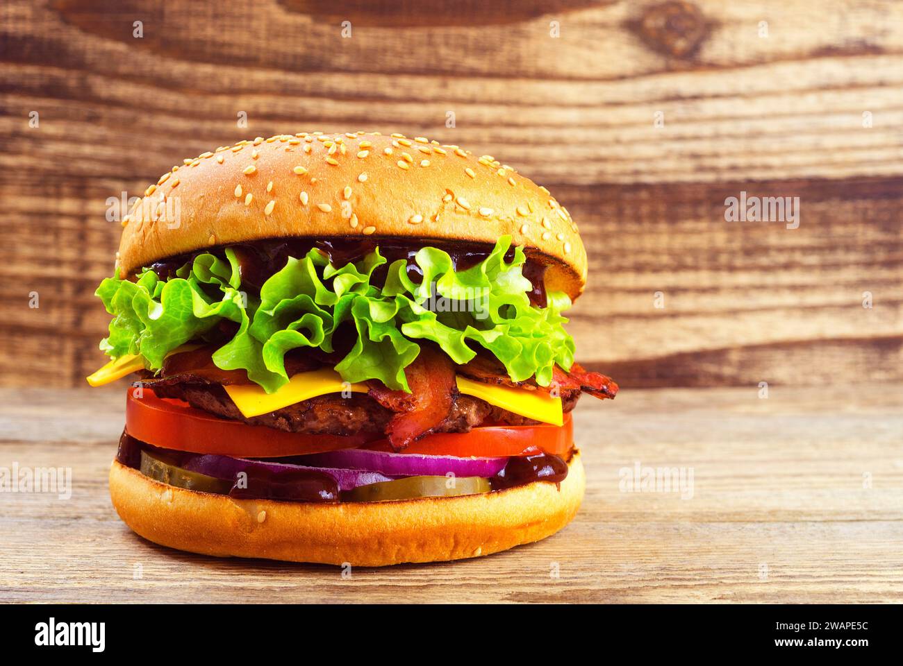 appetizing burger on a wooden background 22 Stock Photo