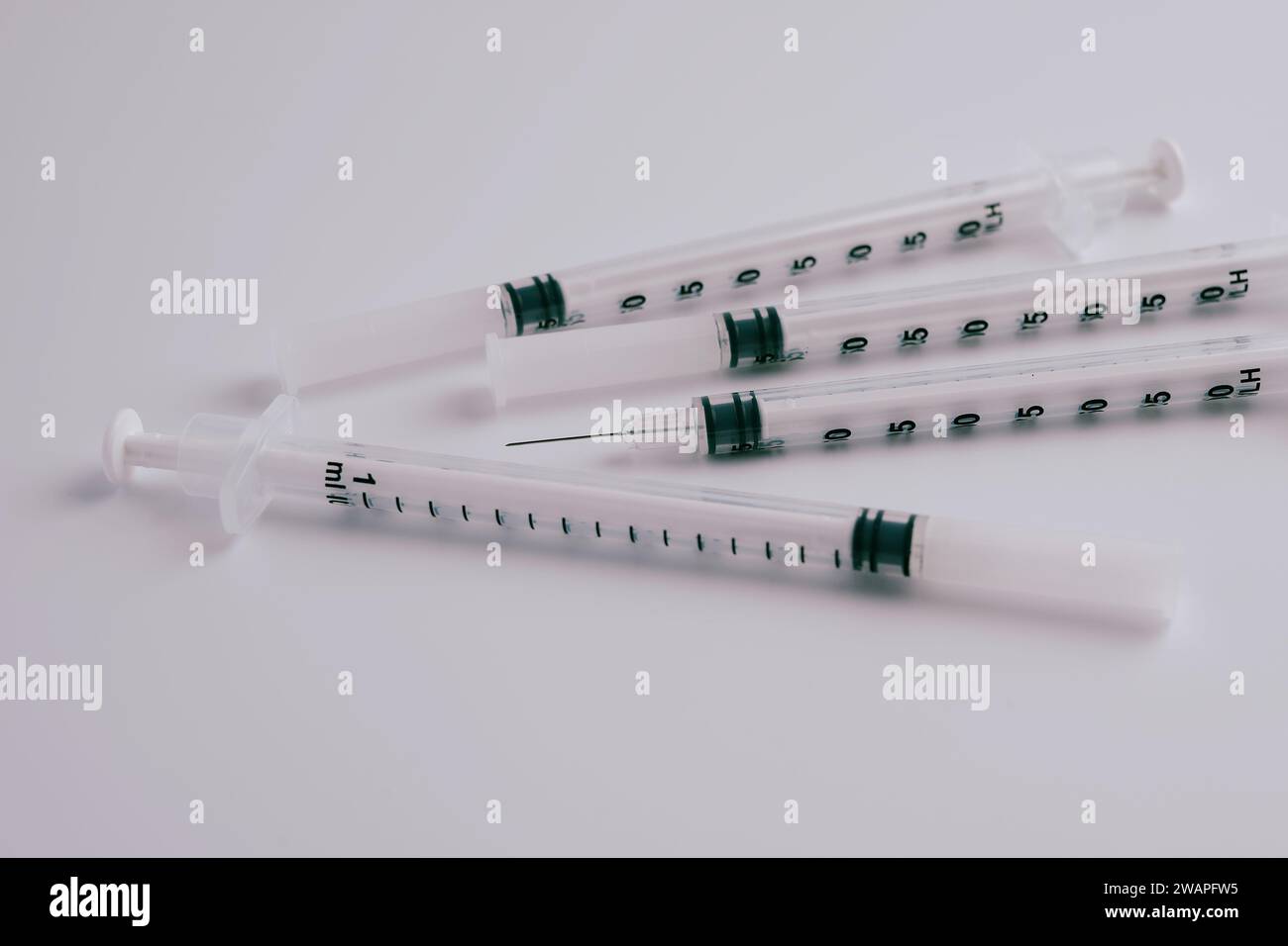 Four syringes and injection needles on a white background Stock Photo ...