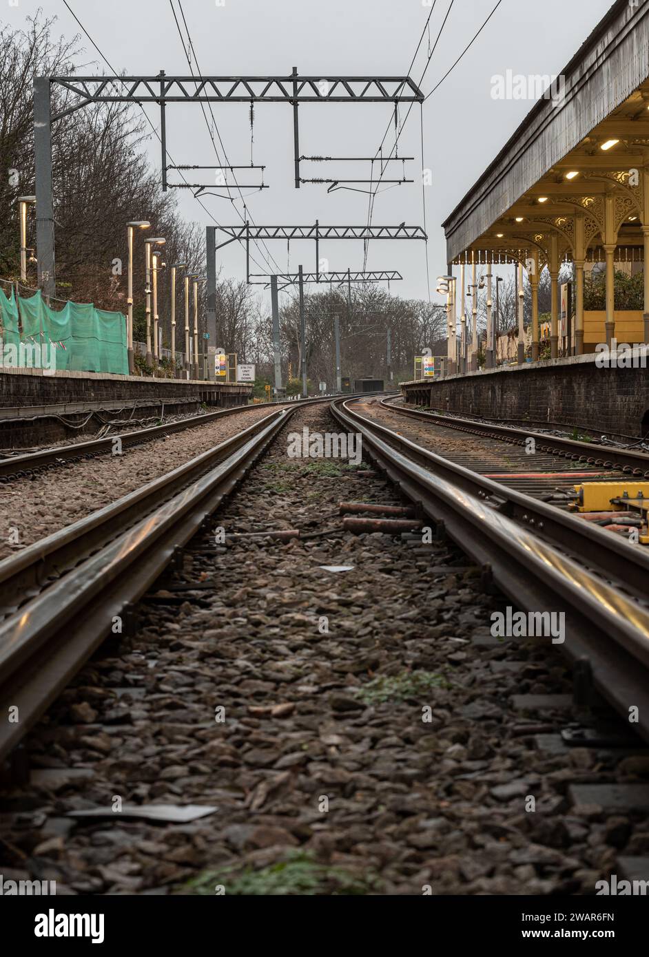 London, UK - Dec 25, 2023 - Railway iron rails from the low perspective. Railroad tracks with limited depth of focus, The Railway system with Metal fr Stock Photo