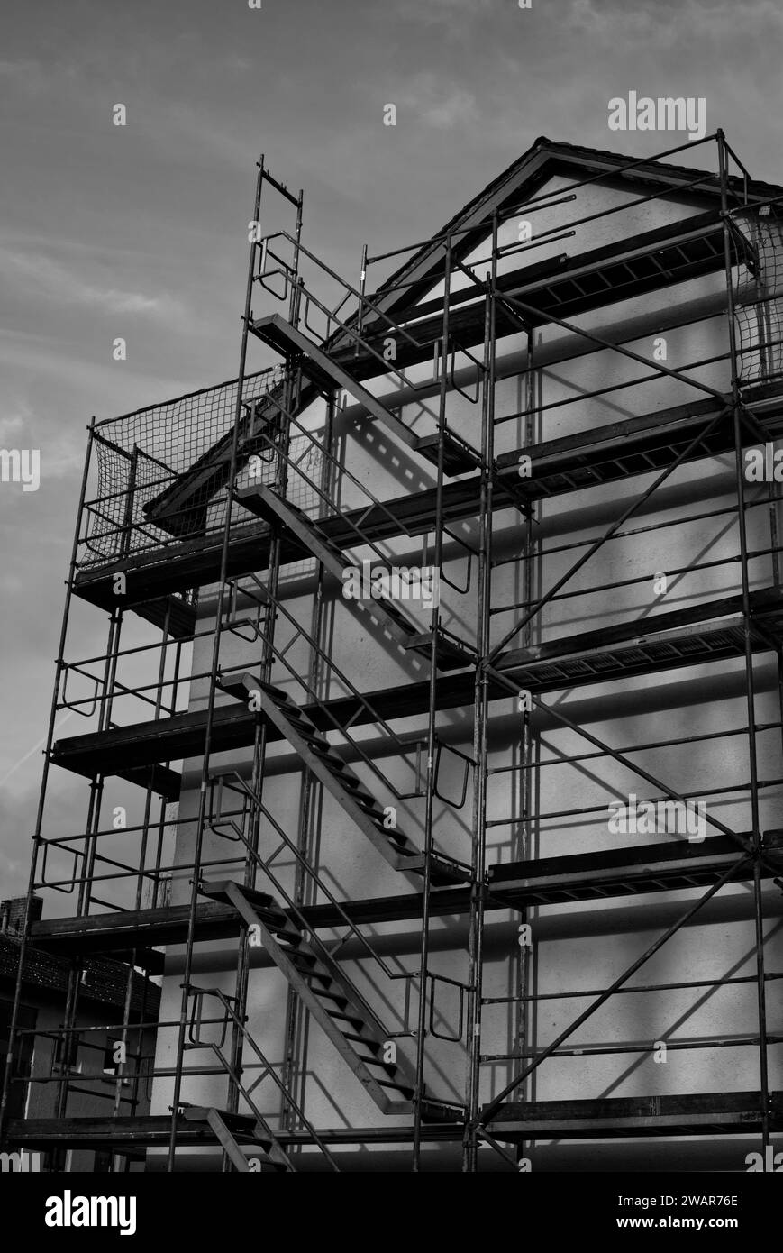 complete scaffolding construction at a house facade in black and white