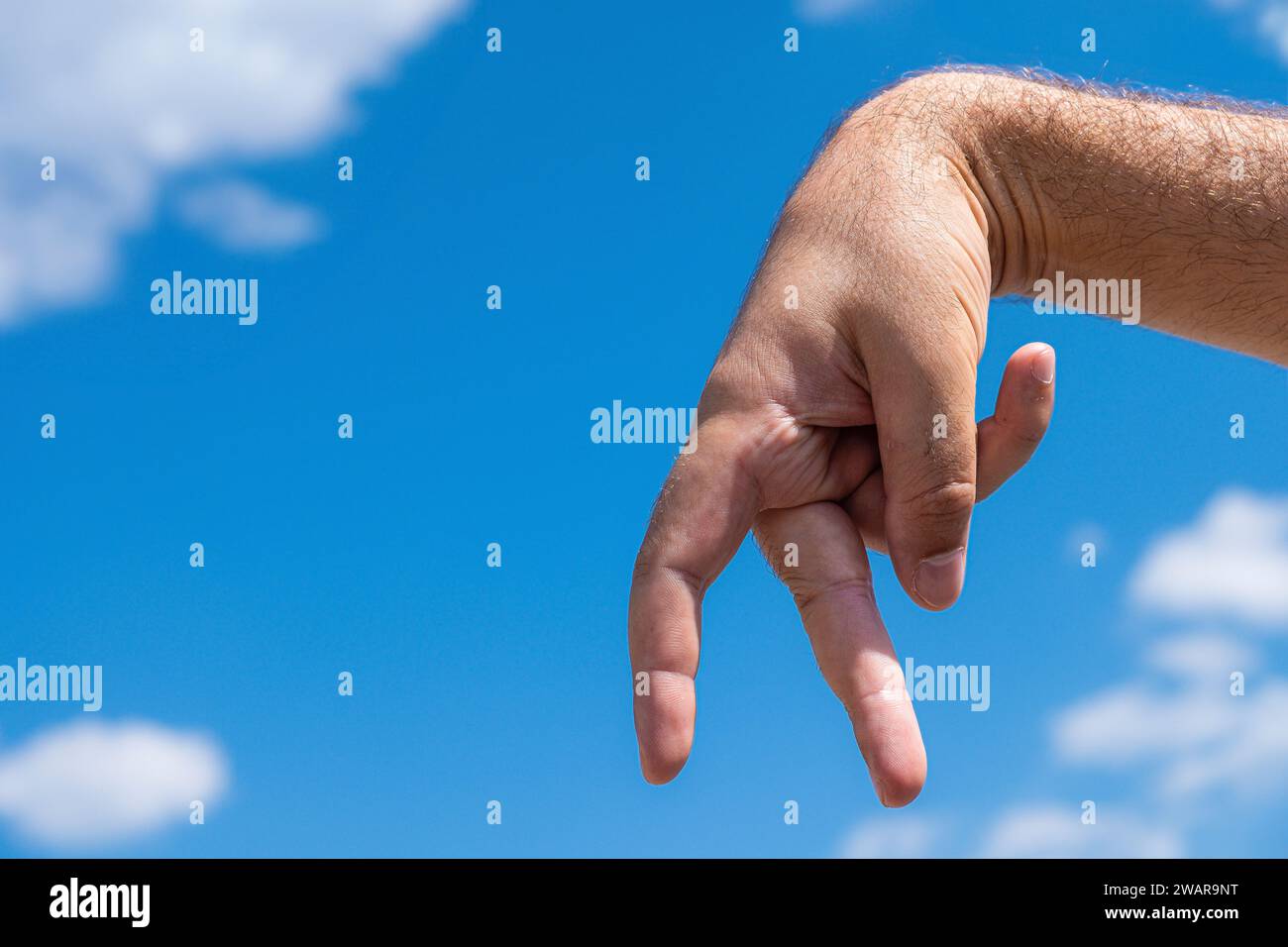 men's fingers step across the blue sky Stock Photo