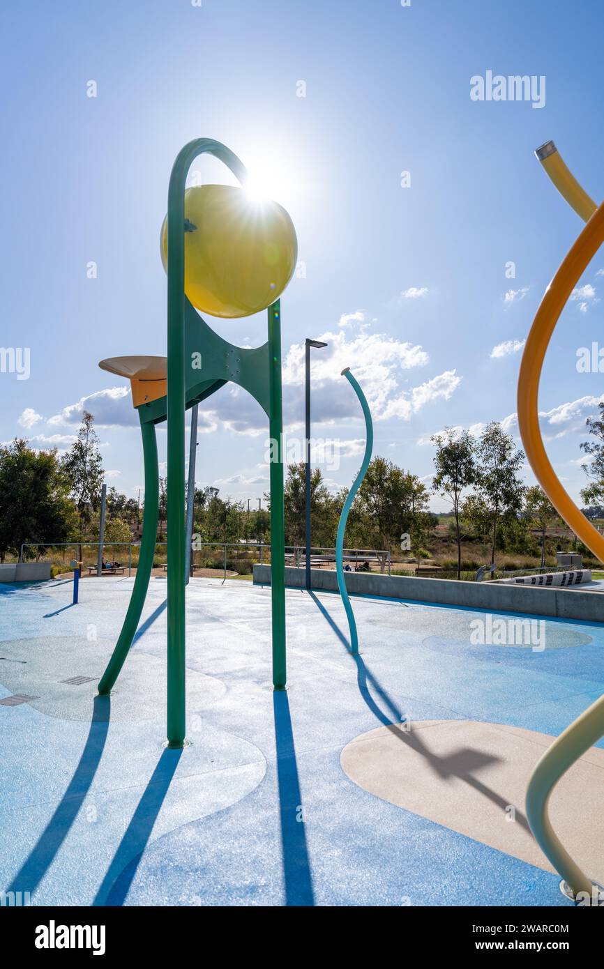 A vibrant outdoor water park with a playground area featuring several pieces of equipment, perfect for kids of all ages to have fun in the sun Stock Photo