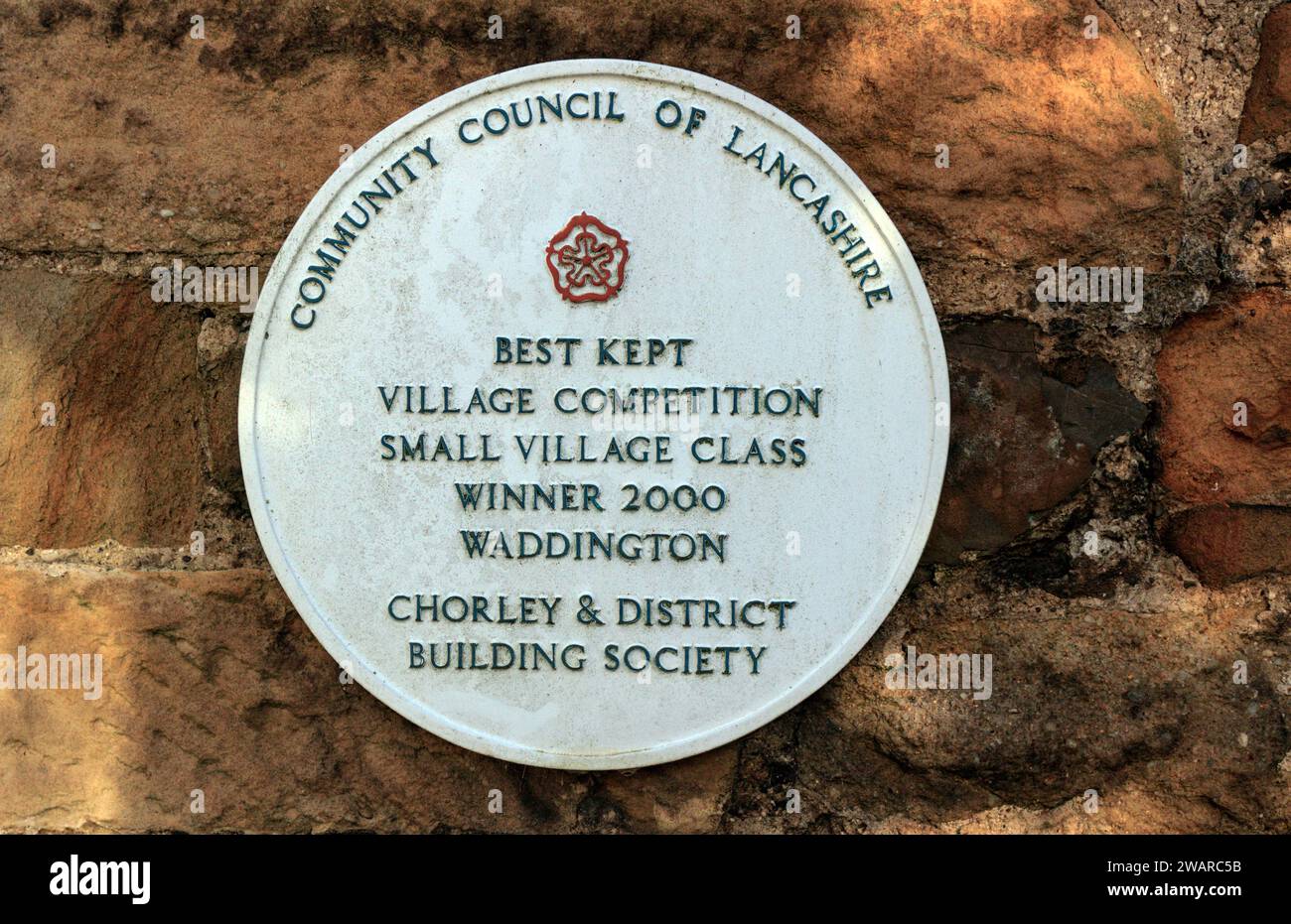 White plaque commemorating Waddington as Best Kept Small Village 2000. Stock Photo