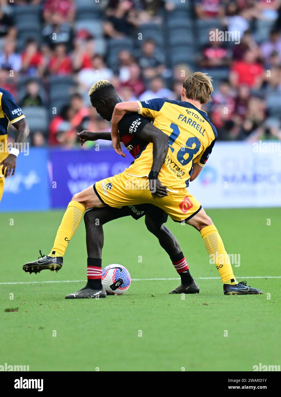 Parramatta, Australia. 06th Jan, 2024. Valentino Kuach Yuel (L) of the Western Sydney Wanderers FC and Jacob Brett Farrell (R) of the Central Coast Mariners seen in action during the 2023-24 A-League Men's season round 11 match between Western Sydney Wanderers FC and Central Coast Mariners at CommBank Stadium. Final score; Central Coast Mariners 1: 0 Western Sydney Wanderers. (Photo by Luis Veniegra/SOPA Images/Sipa USA) Credit: Sipa USA/Alamy Live News Stock Photo