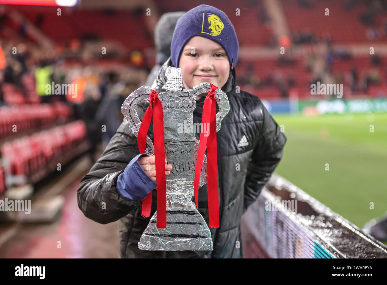 A young fan shows off his home made tin foil FA Cup during the Emirates