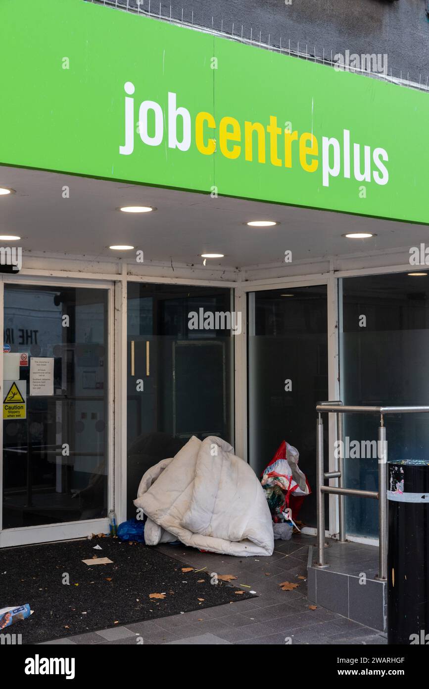 Homeless person's bedding and belongings in doorway of Job Centre Plus