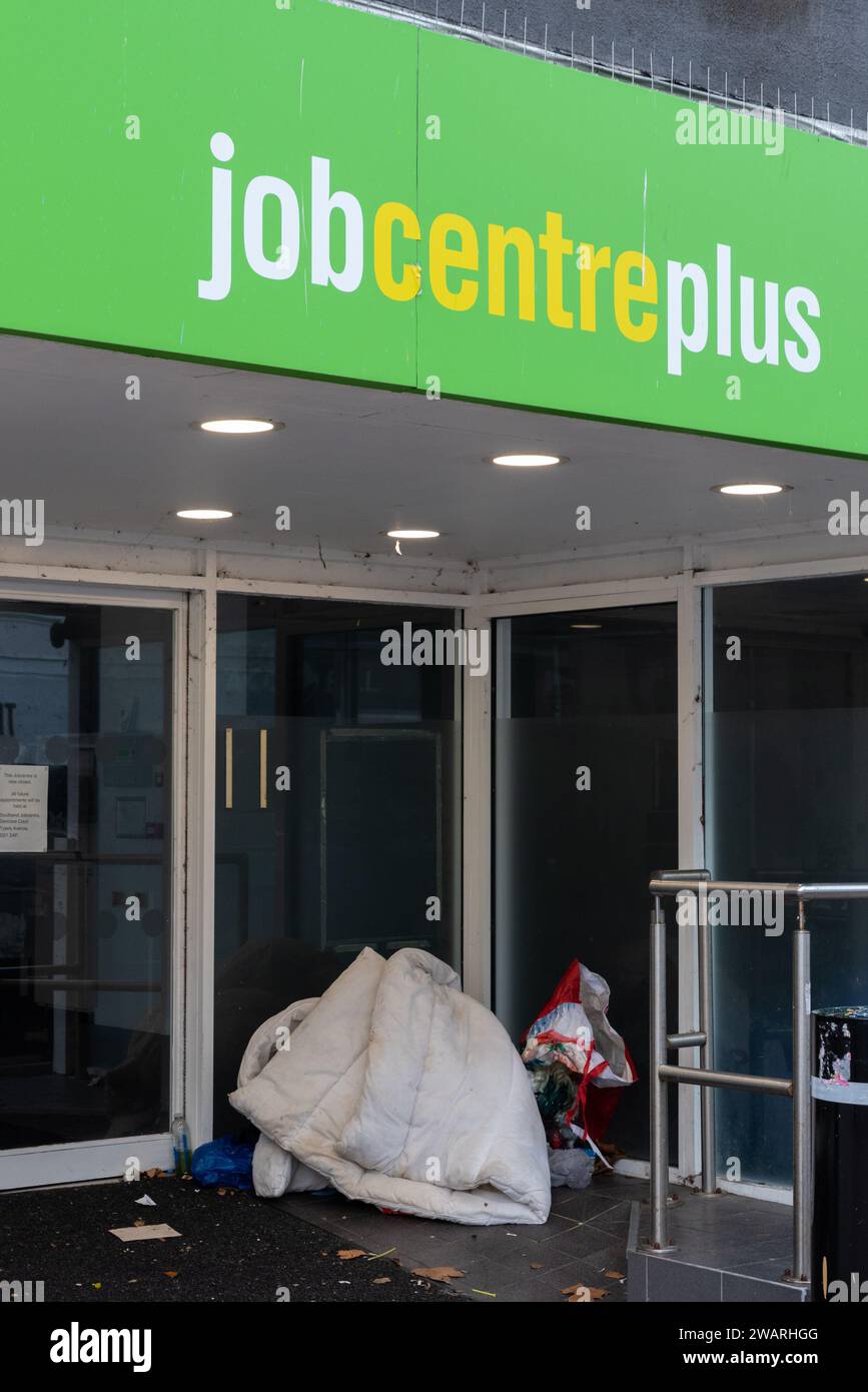 Homeless person's bedding and belongings in doorway of Job Centre Plus