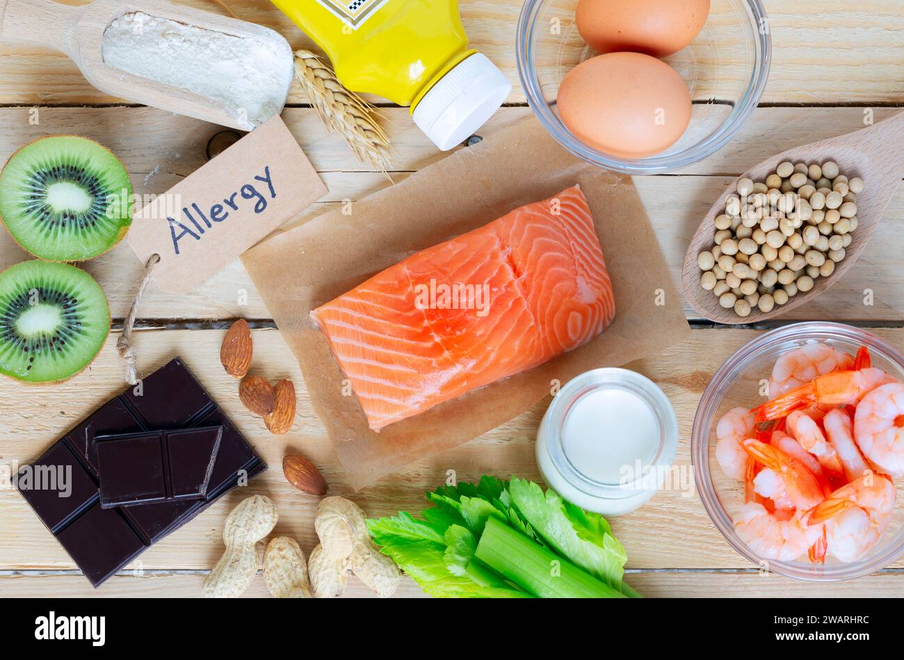 Composition with common food allergens including egg, milk, soya, nuts, fish, seafood, wheat flour, mustard, dried apricots and celery Stock Photo