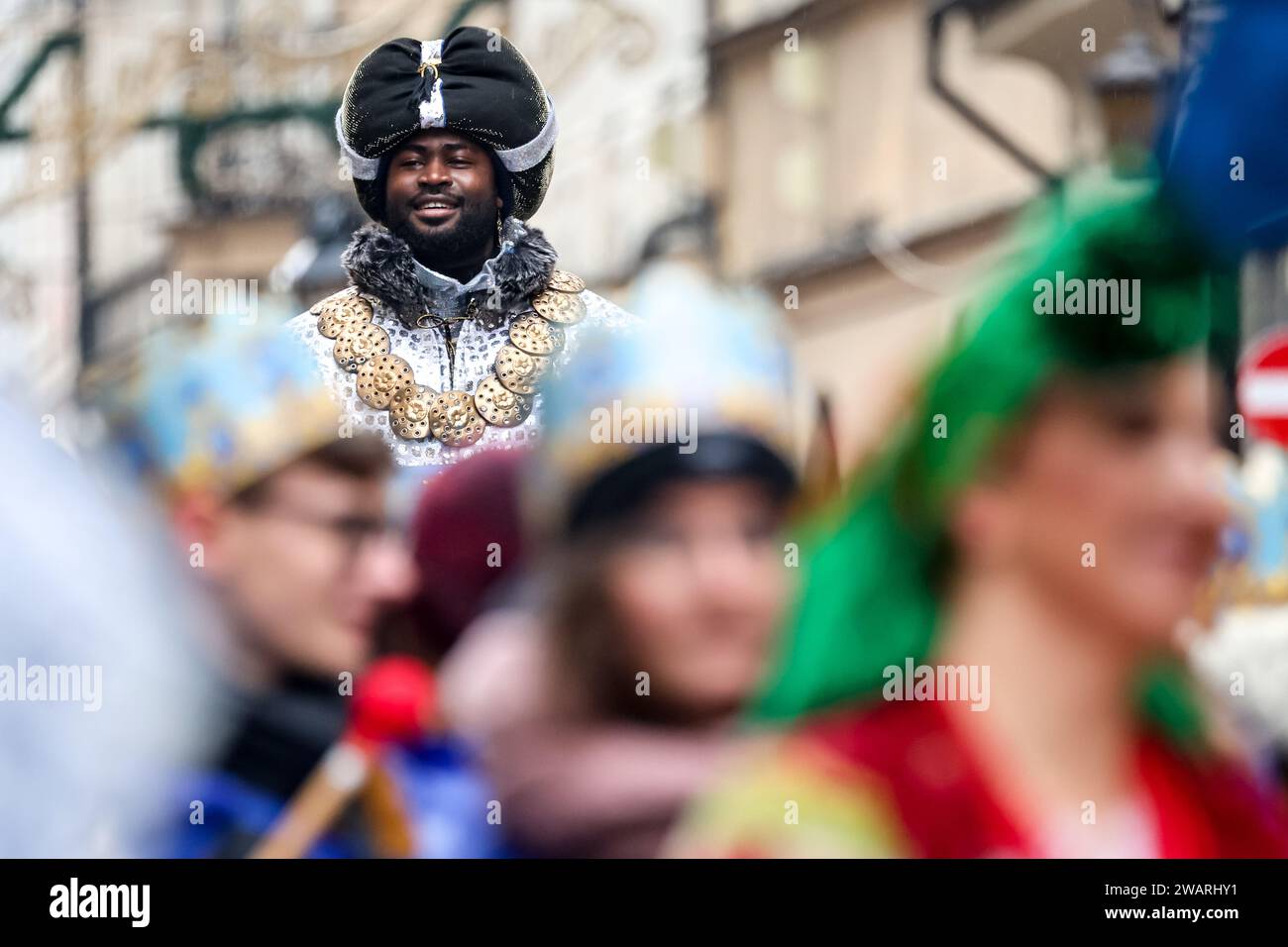 An actor who plays one of the Wise Man, perform Nativity Play on the street of Old Town of Krakow, Poland on January 6, 2024. January 6 is Polish Three Kings holiday, when mass celebrations take place and Nativity Play is performed by the actors together with the members of the public. The celebrations have the character of a family festival. Over 800 cities and towns performed the Play in Poland this year. Hundreds of people attended the festival despite cold rainy weather. Stock Photo