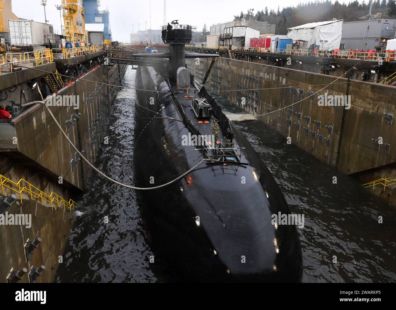 Bremerton, United States. 28 December, 2023. The U.S. Navy nuclear-power Ohio-class ballistic missile submarine USS Nevada is docked in Delta Pier dry dock at Trident Refit Facility Naval Bangor at Base Kitsap Bremerton, December 28, 2023 in Bremerton, Washington.  Credit: MC2 Adora Okafor/U.S. Marines/Alamy Live News Stock Photo