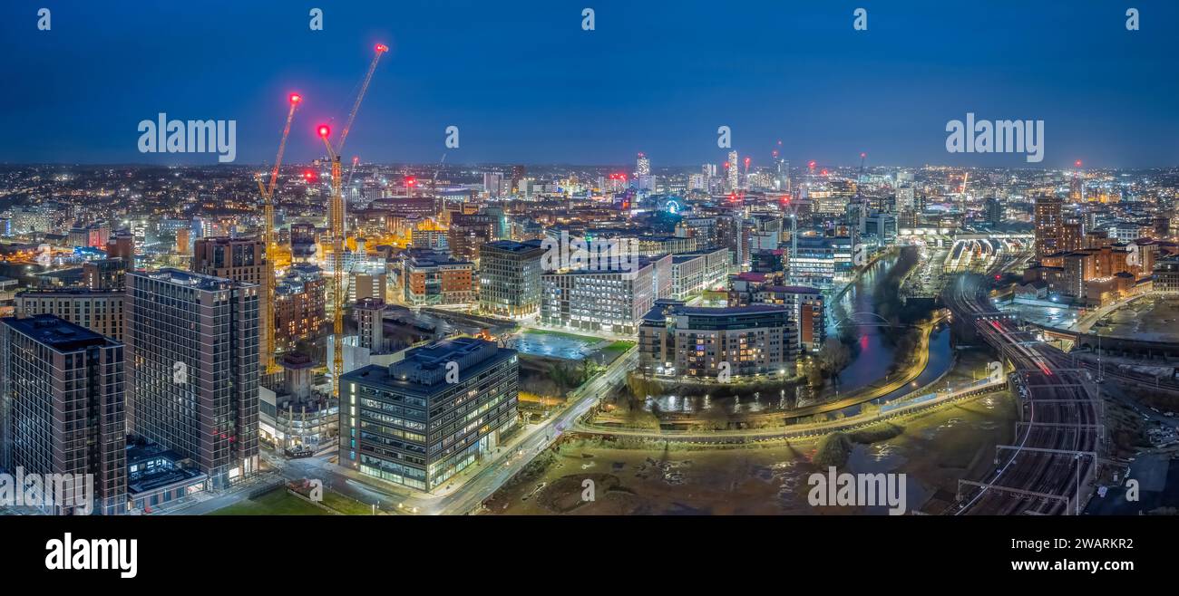 Leeds West Yorkshire aerial view of the city centre at night looking north from near the train station showing construction work and redevelopment. Stock Photo