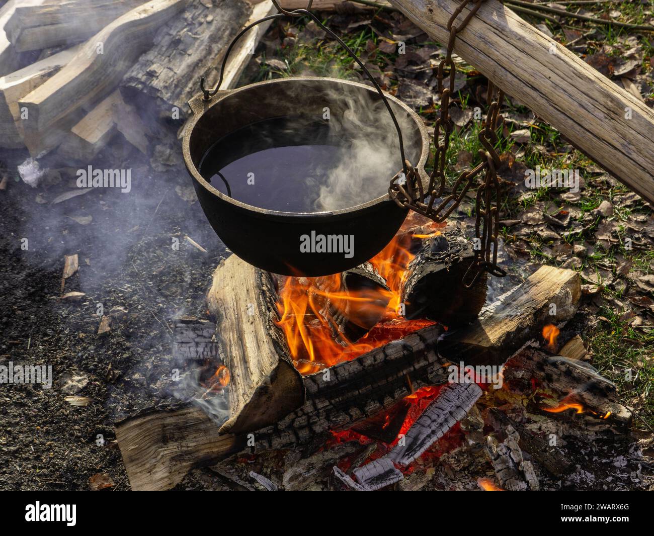 Tourist camp with fire. cooking pot over campfire. Pot On The Fire