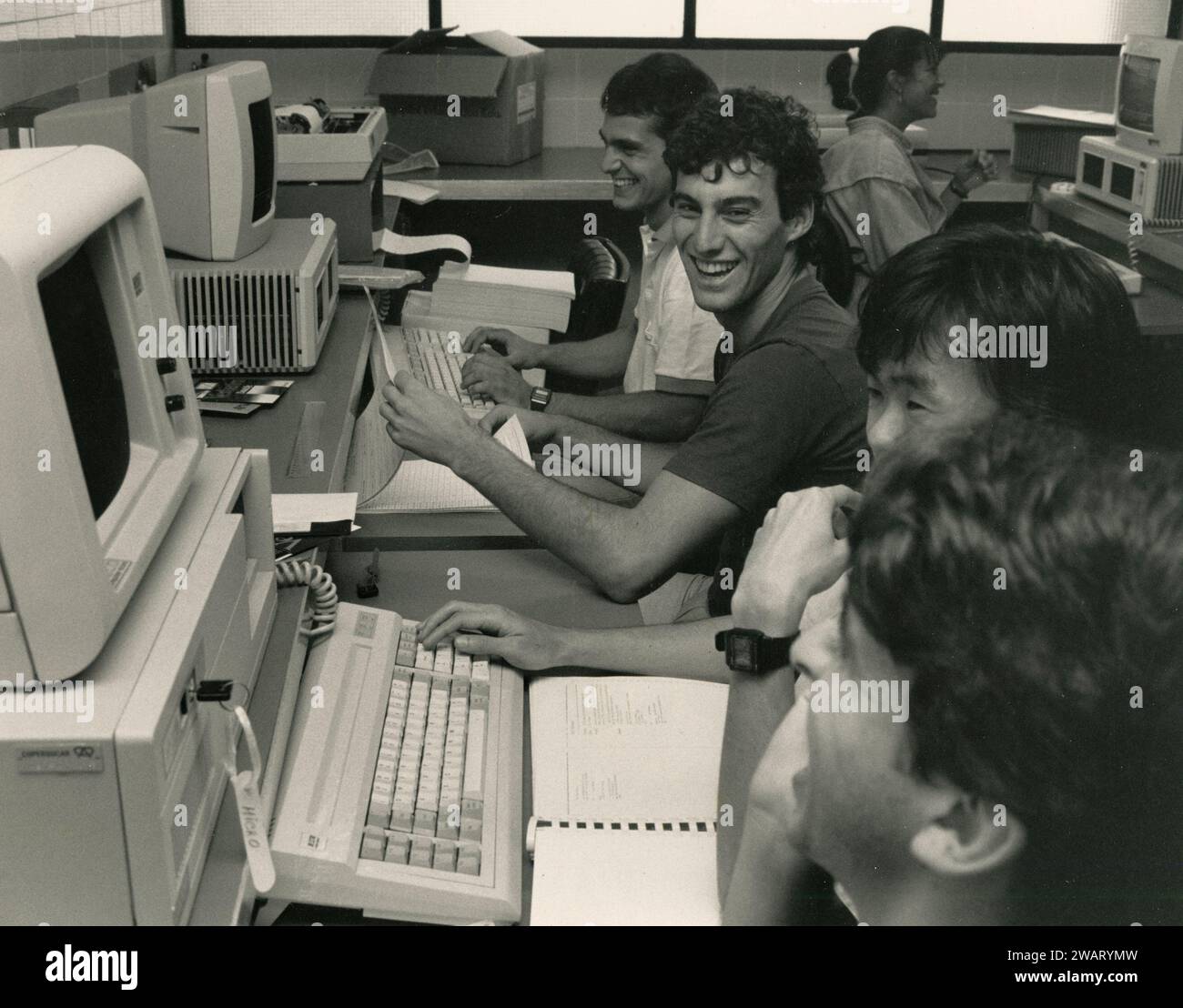 Boys operating at personal computer workstation, 1980s Stock Photo