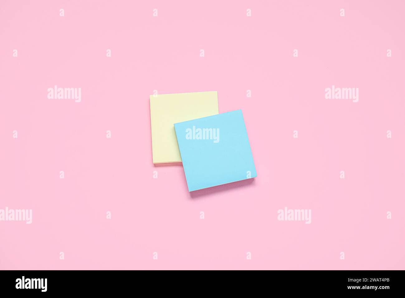Sticky notes on pale pink background Stock Photo