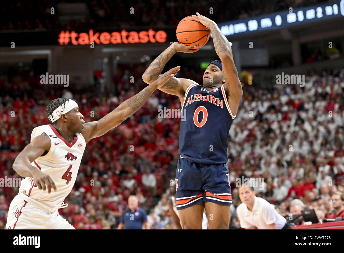 Auburn guard K.D. Johnson (0) shoots over Arkansas guard Davonte Davis ...