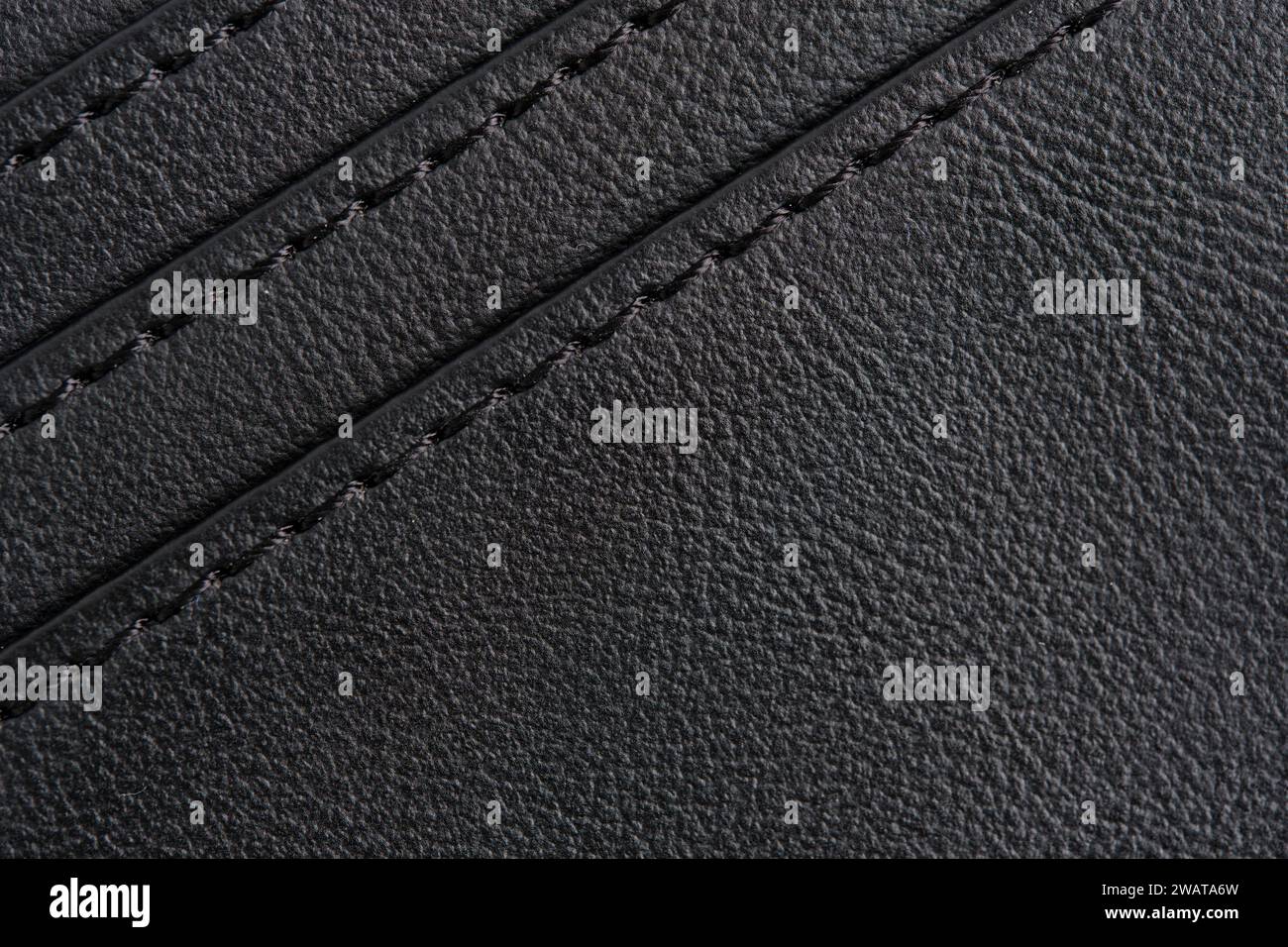 Background is made black leather stitched with black threads Stock Photo