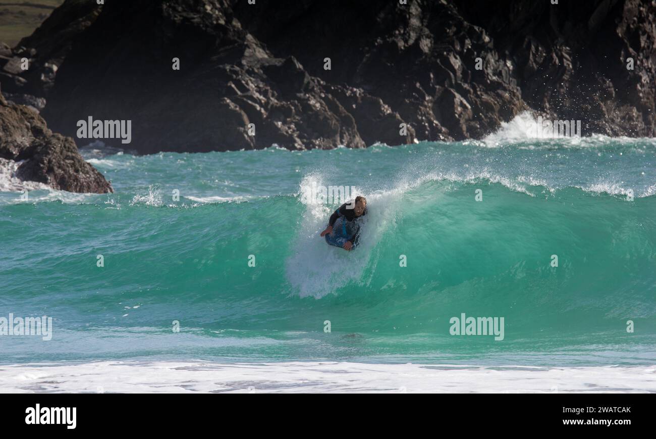 Body boarding or short boarding, riding a wave; Kynance Cove, Cornwall Cut turn into the wave. Stock Photo