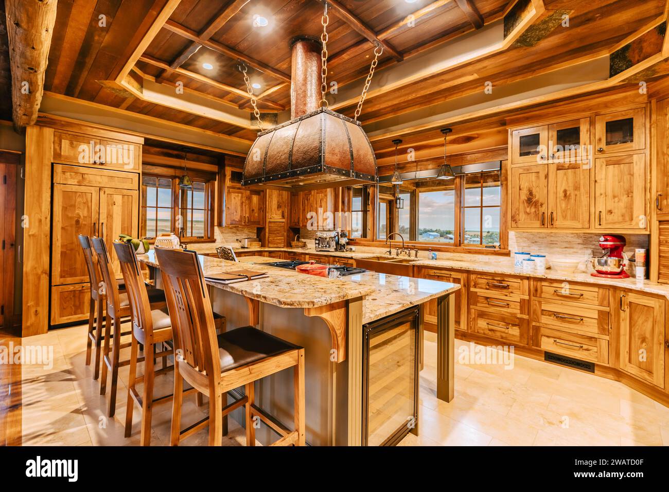 This modern kitchen features wooden cabinetry paired with granite ...