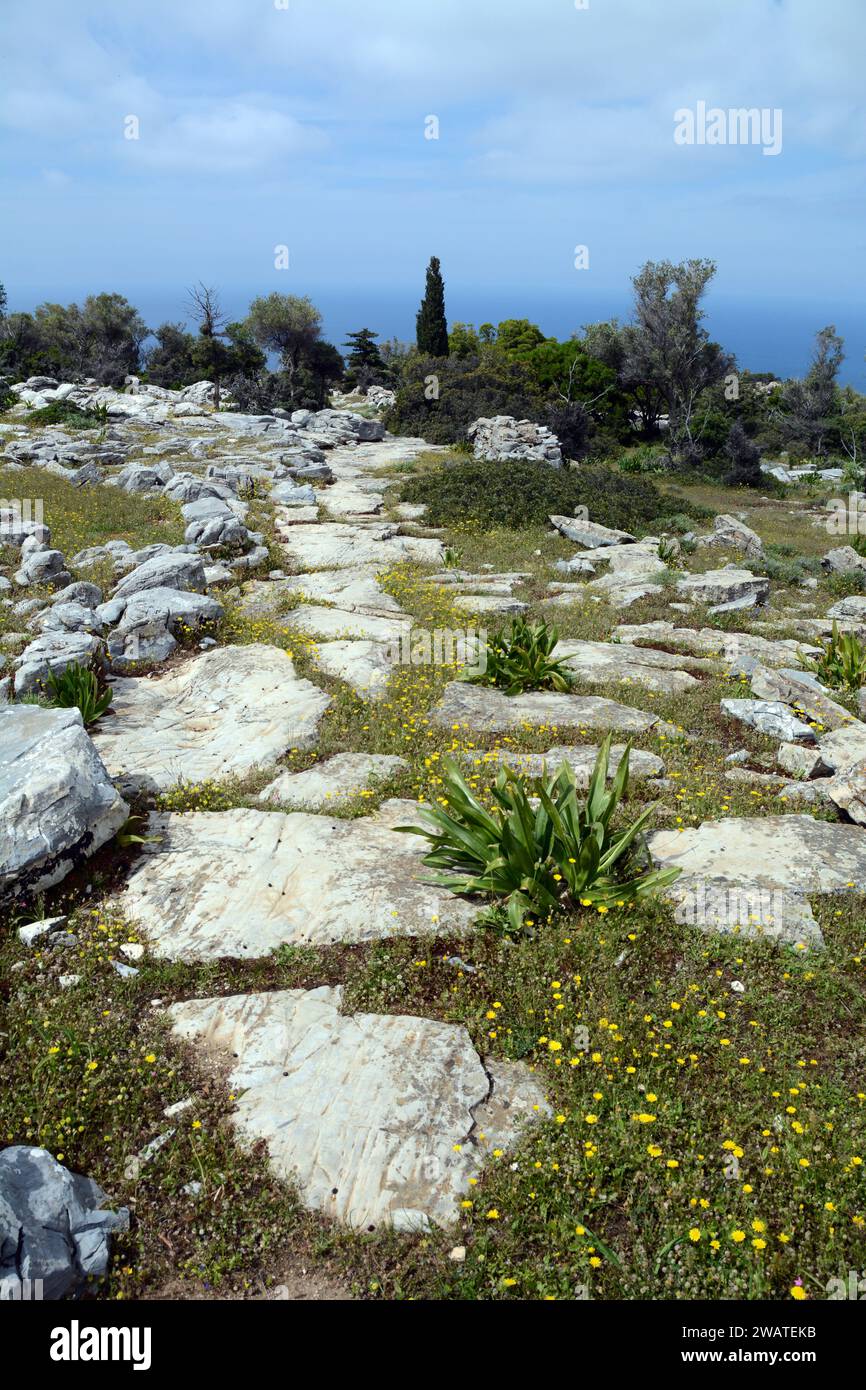 A hiking trail in the hills overlooking the Aegean Sea, on the north coast of the Greek Island of Ikaria, near Evdilos, Greece. Stock Photo