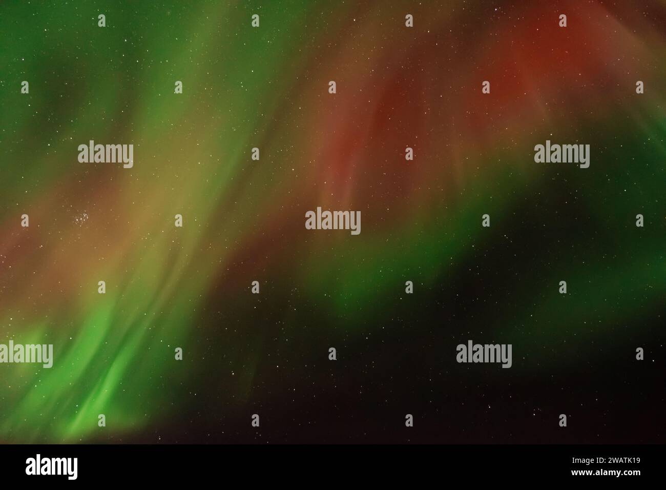 Amazing aurora borealis in the starry sky. Green and red northern ...