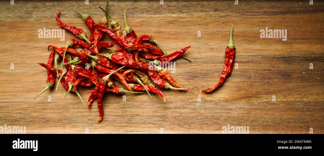 Red chilli peppers on the wooden background. Stock Photo