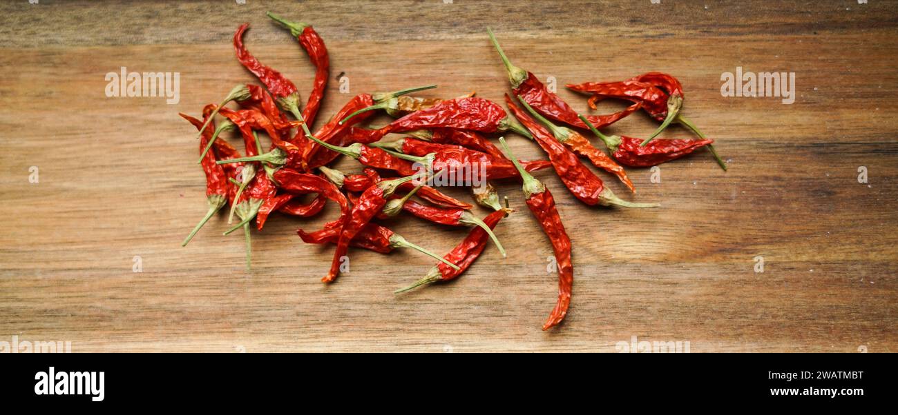 Red chilli peppers on the wooden board. Stock Photo