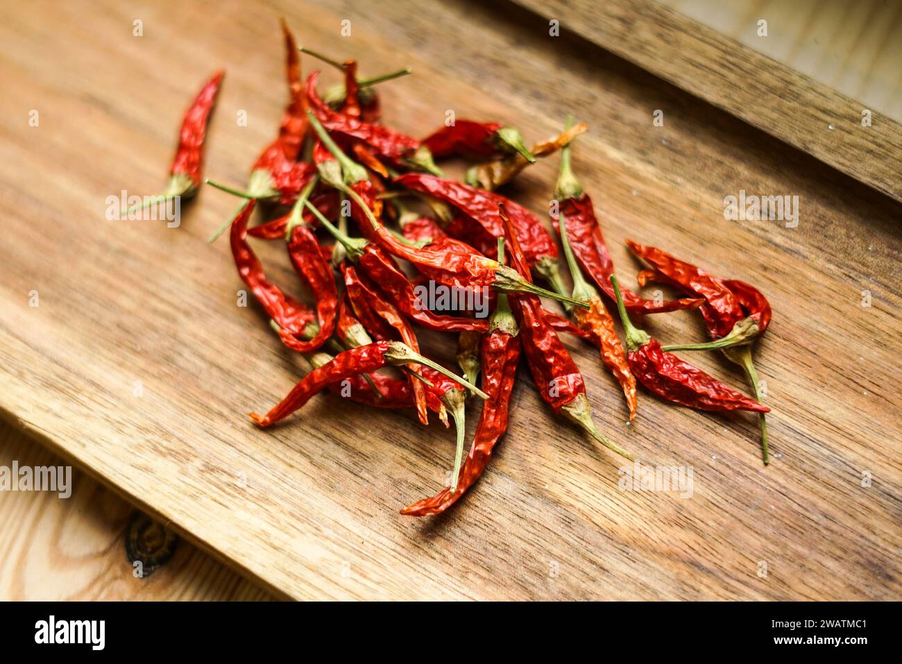 Red chilli peppers on the wooden board. Stock Photo