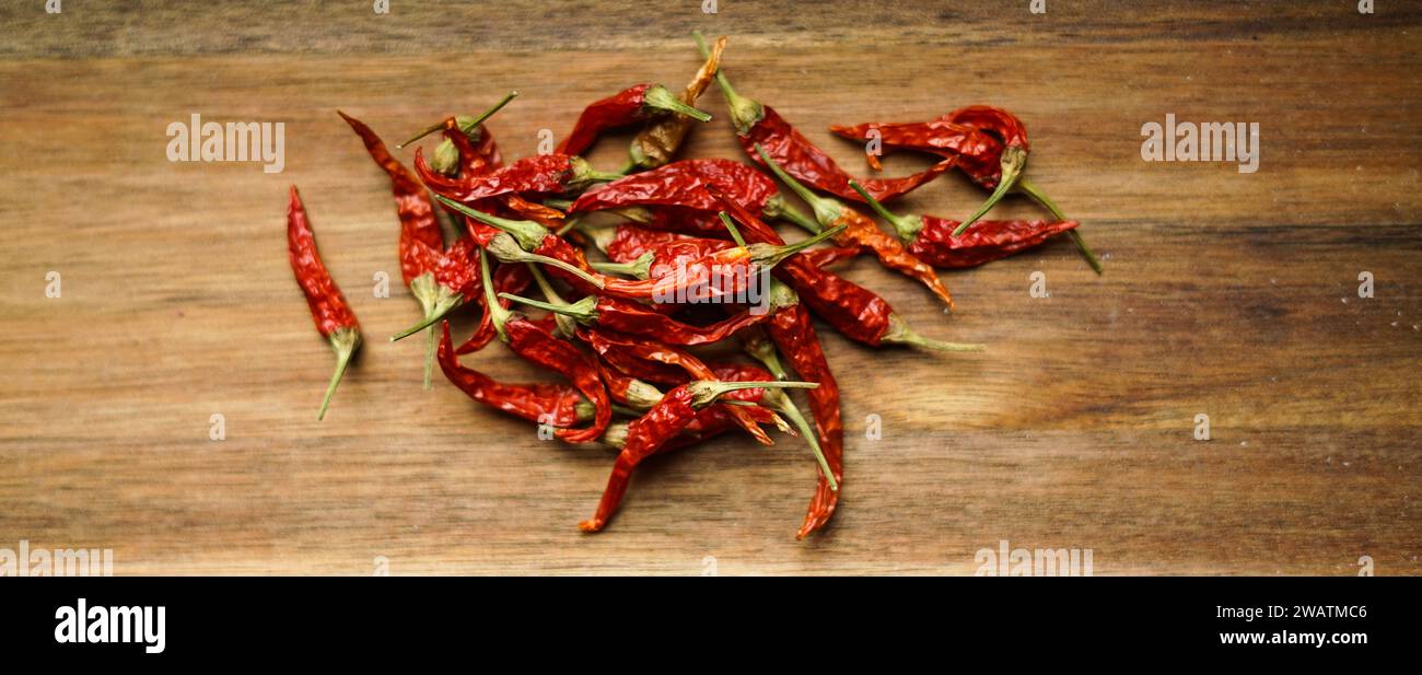 Red chilli peppers on the wooden board. Stock Photo