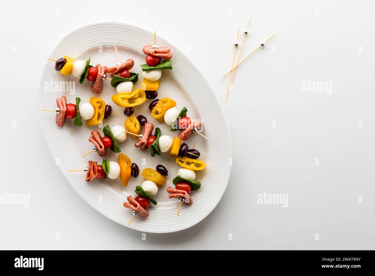 A platter of colourful antipasto kebab appetizers with copy space to