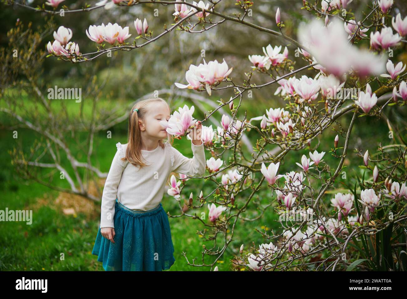 Springtime Kids Outside Adorable preschooler girl enjoying nice spring day in park during ...