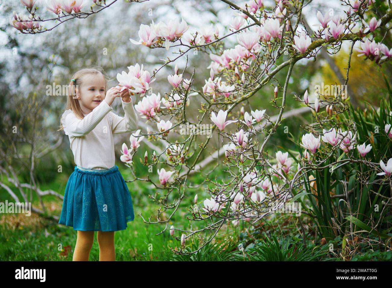 Springtime Kids Outside Adorable preschooler girl enjoying nice spring day in park during ...