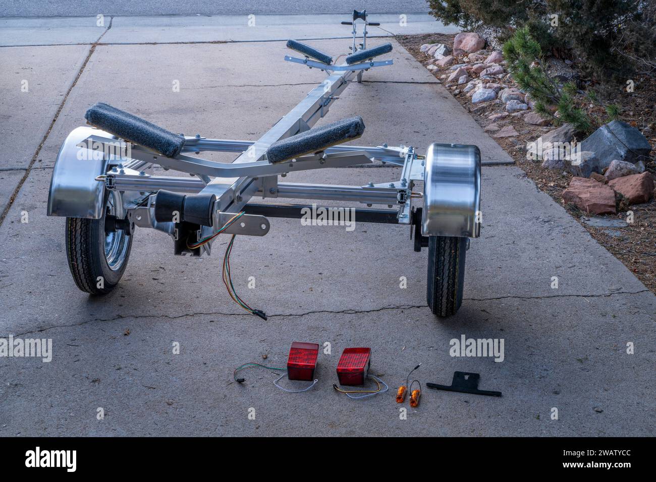 assembling a light and long aluminum kayak or canoe trailer in a driveway Stock Photo Alamy