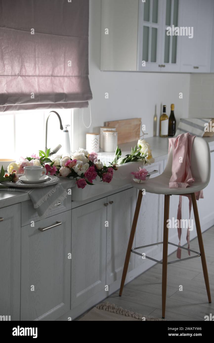 Bunch of beautiful peonies in kitchen sink Stock Photo - Alamy