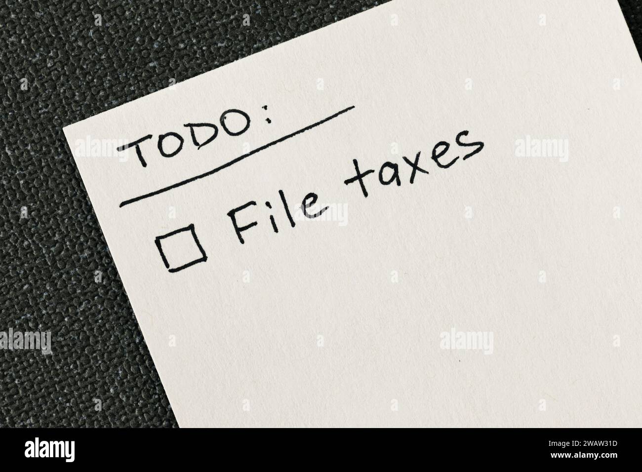 Hand written to-do list with 'File taxes' reminder and a checkbox ...