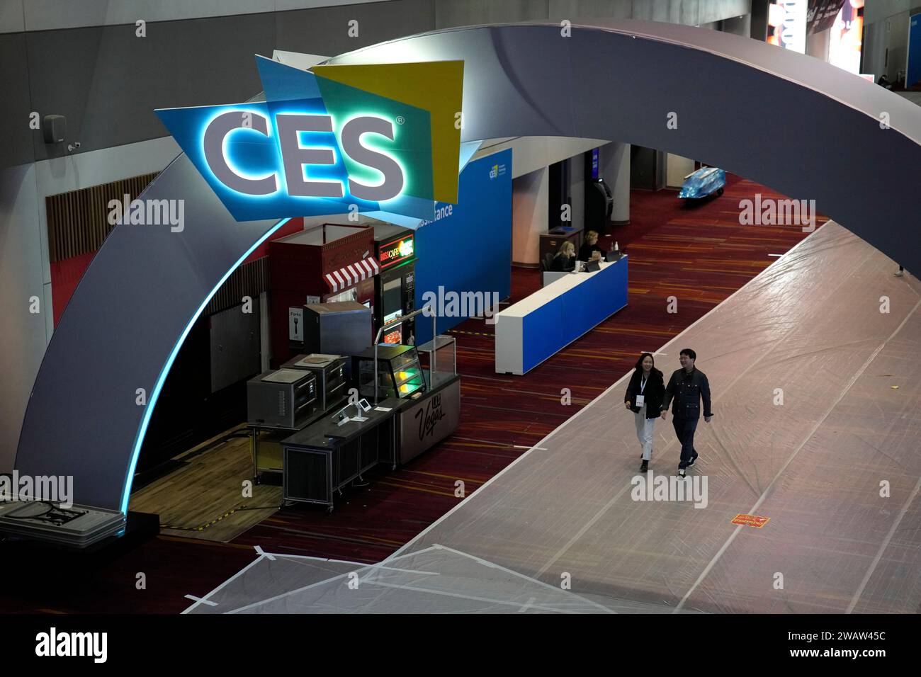 People walk through the Las Vegas Convention Center during setup ahead ...