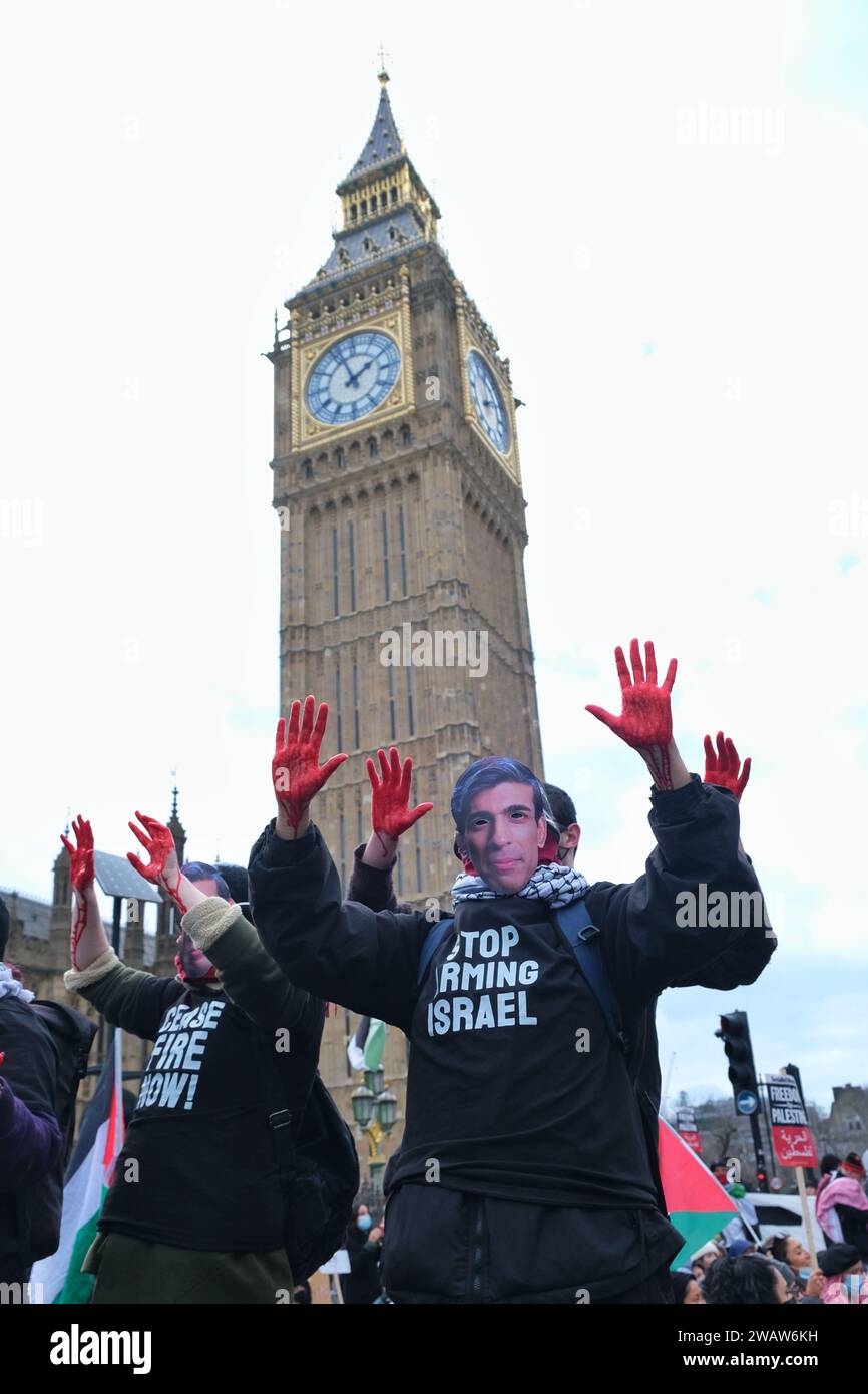 London, UK. 6th January, 2024. Protesters with bloodied hands wear face masks with the photos of David Cameron, Benjamin Netanyahu and Rishi Sunak. Around a thousand Palestine supporters, including from activist groups Sisters Uncut and BLM, marched through Westminster from St James's Park towards Parliament Square, where the demonstrators were contained by a police cordon, and imposed conditions curtailing further movement. Credit: Eleventh Hour Photography/Alamy Live News Stock Photo
