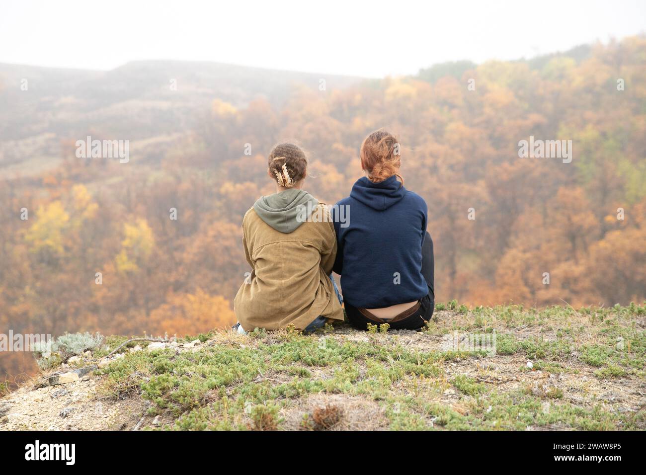 Girls sitting on a hill top hi-res stock photography and images - Alamy