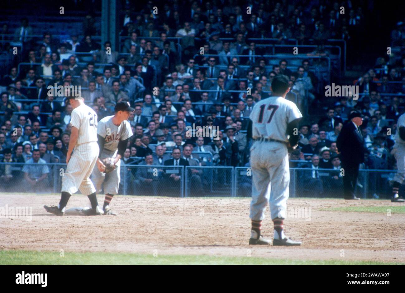 BRONX, NY - 1955:  Billy Hunter #20 of the New York Yankees stands on second base as Nellie Fox #2 of the Chicago White Sox holds the ball during an MLB game circa 1955 at Yankee Stadium in the Bronx, New York.  The White Sox shortstop is Chico Carrasquel #17.  (Photo by Hy Peskin) *** Local Caption *** Nellie Fox;Billy Hunter;Chico Carrasquel Stock Photo