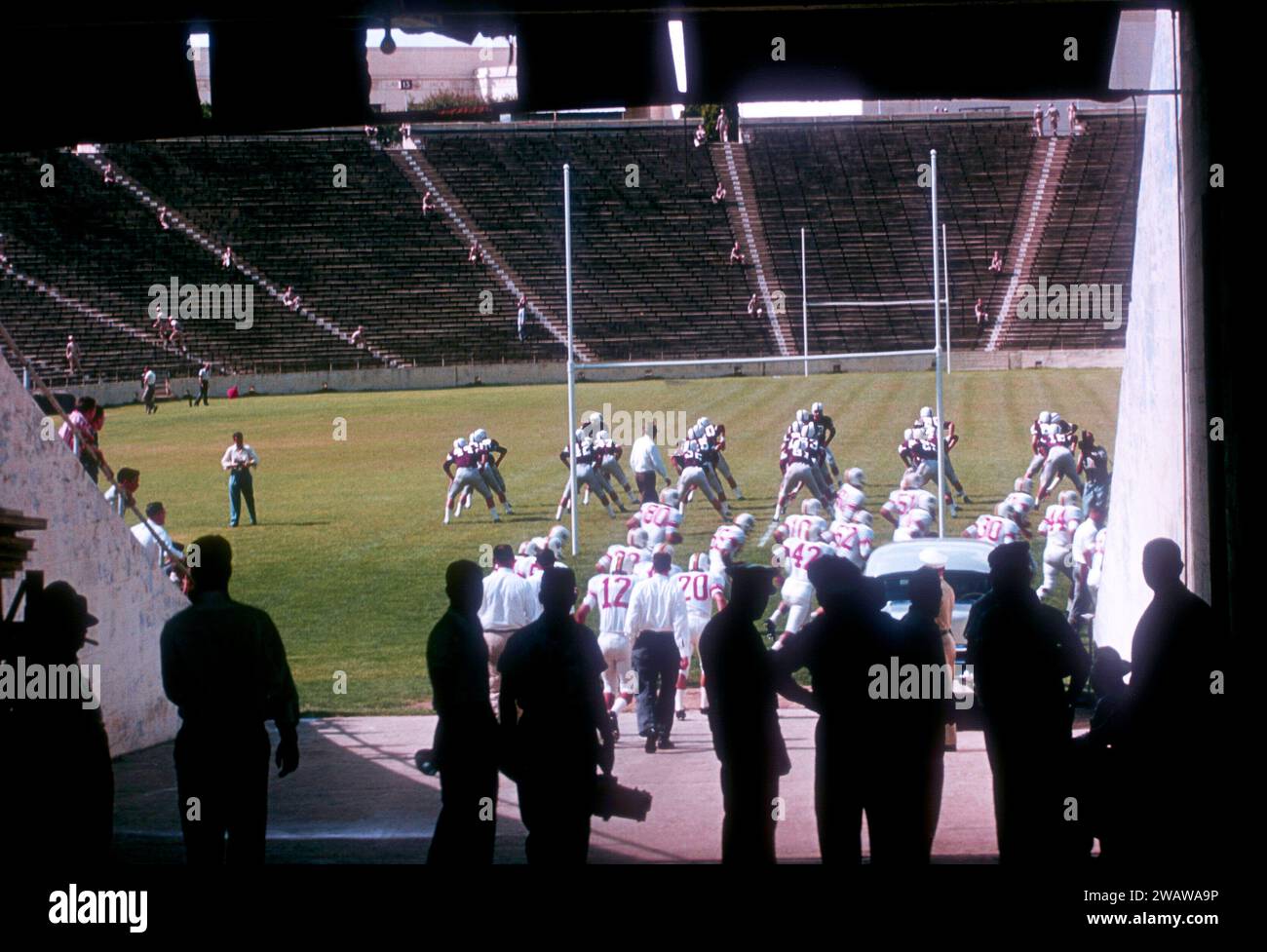 DALLAS, TX - SEPTEMBER 21:  General view of players from the #2 ranked Texas A&M Aggies stretch as the Maryland Terrapins run onto the field before an NCAA game on September 21, 1957 at the Cotton Bowl in Dallas, Texas.  The Aggies defetead the Terrapins 21-13.  (Photo by Hy Peskin) Stock Photo