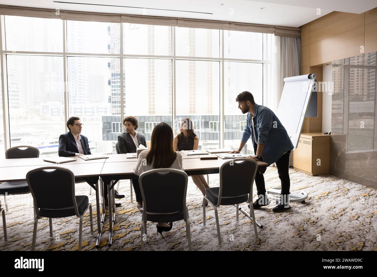 Young Arab project manager man presenting startup to colleagues Stock Photo